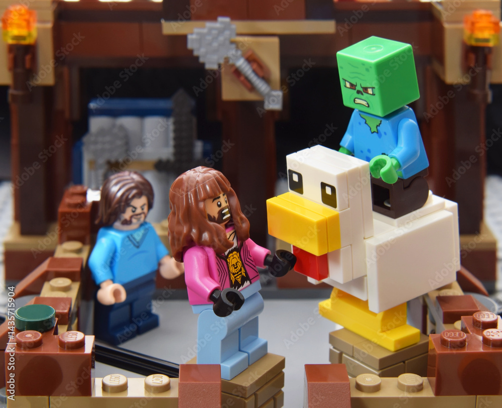 Obraz premium Lego minifigure of Garrett character from video game Minecraft movie is boxing on ring against a chicken. Editorial illustrative image of popular plastic toys.