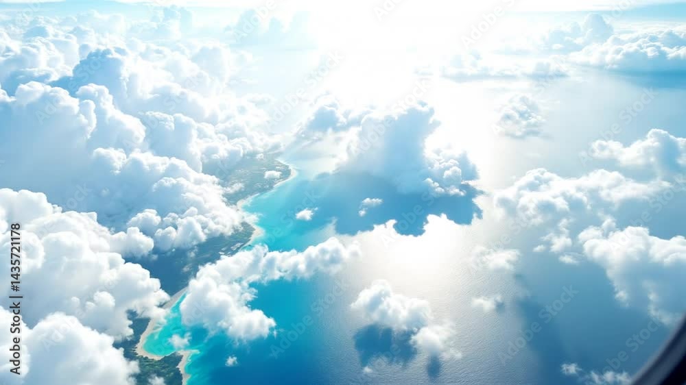 A stunning aerial view of fluffy white clouds floating gracefully over a vibrant tropical coastline, taken from the window of a smoothly flying plane