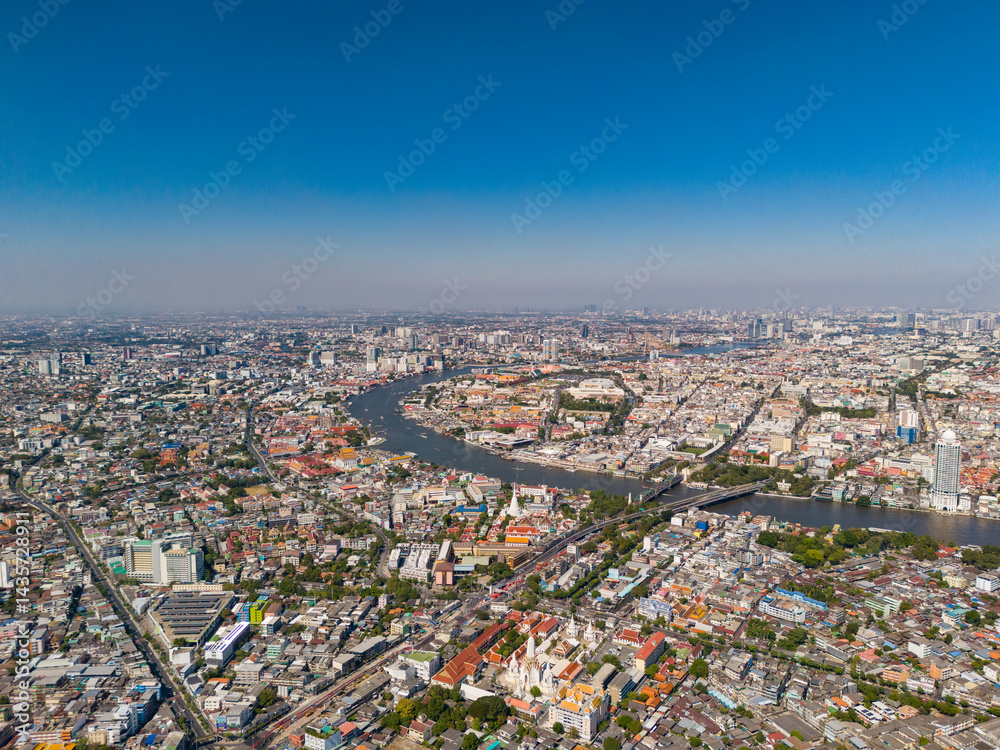 Fototapeta premium Bangkok aerial view of Rattanakosin Island with Chao Phraya River and low-rise buildings of the old city