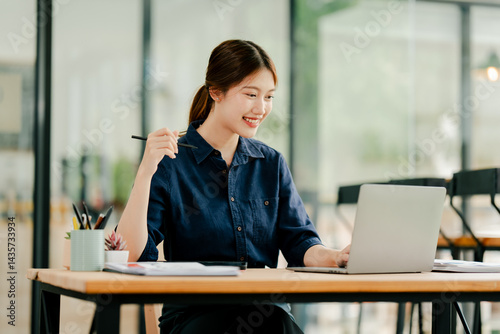 Young Asian woman doing financial accounting and taxes for a company Organizing account analysis reports Investment information Financial and tax system concepts