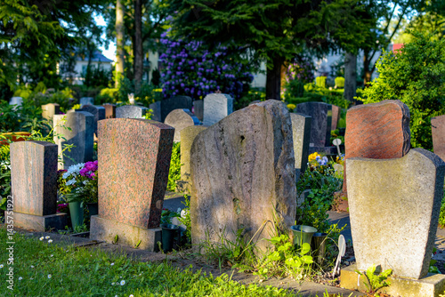 Back of several gravestones in a cemetery. No personal data can be seen.