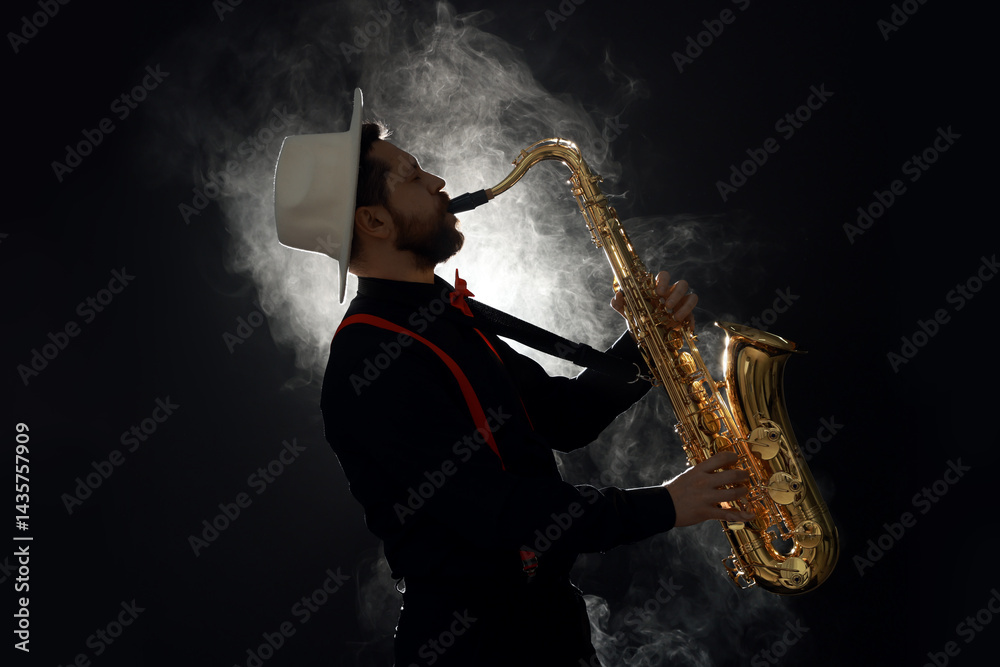 Naklejka premium Professional musician playing saxophone on black background with smoke