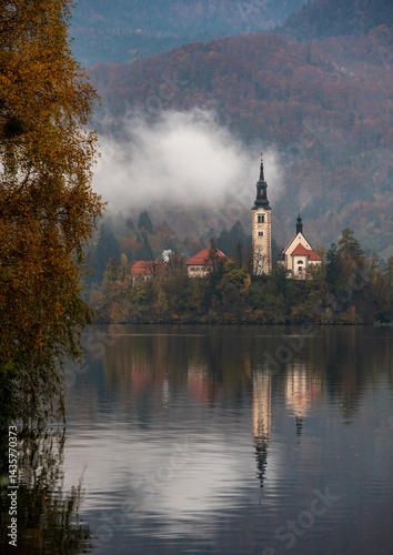 Obraz na płótnie Assumption of mary pilgrimage church on lake bled, surrounded by mountains and colorful autumn foliage, in slovenia w salonie