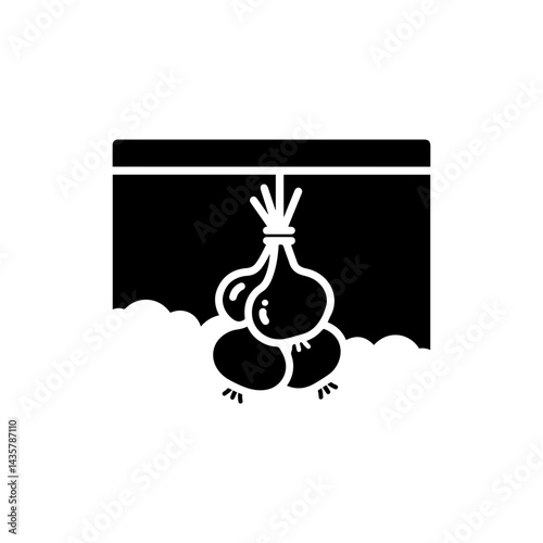 A Bundle of Onions Tied with String Hanging in a Dark Rustic Cellar