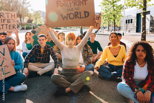 Young activists holding protest signs for environmental conservation and sustainability