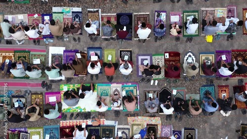 overhead shot capturing the spiritual atmosphere of the Eid prayer gathering under the morning sky.