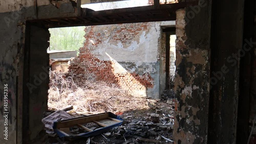 Destroyed building. Old abandoned house shot from inside. War destruction. Ruins. Interior of war-damaged apartment in city shows collapsed ceilings, burnt walls. Empty, destroyed building interior