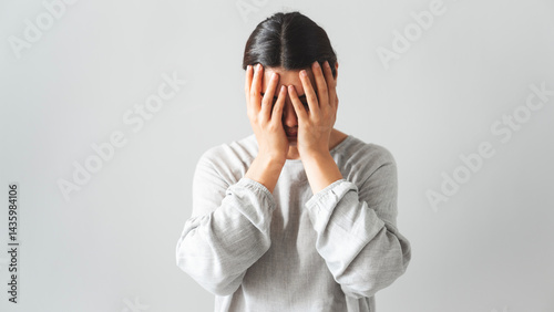 Regretful woman holds her head with her hands
