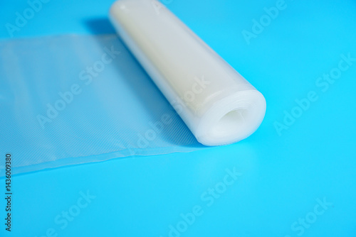 Roll film for a product vacuum sealer machine on a blue background.