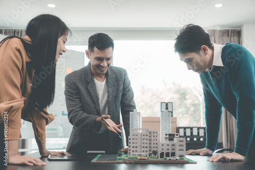 Business team signing investment agreement for residential real estate. Group of professionals in suits meeting in office with financial agreement documents on table.