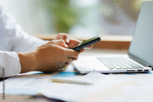Amidst the scattered paperwork, the determination and diligence of an employee shine through, striving for flawless accuracy in the company’s annual review report.