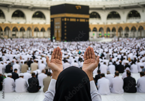 Muslims praying at the Kaaba in Mecca, Saudi Arabia, during Hajj pilgrimage. Hands raised in prayer towards the holy site.