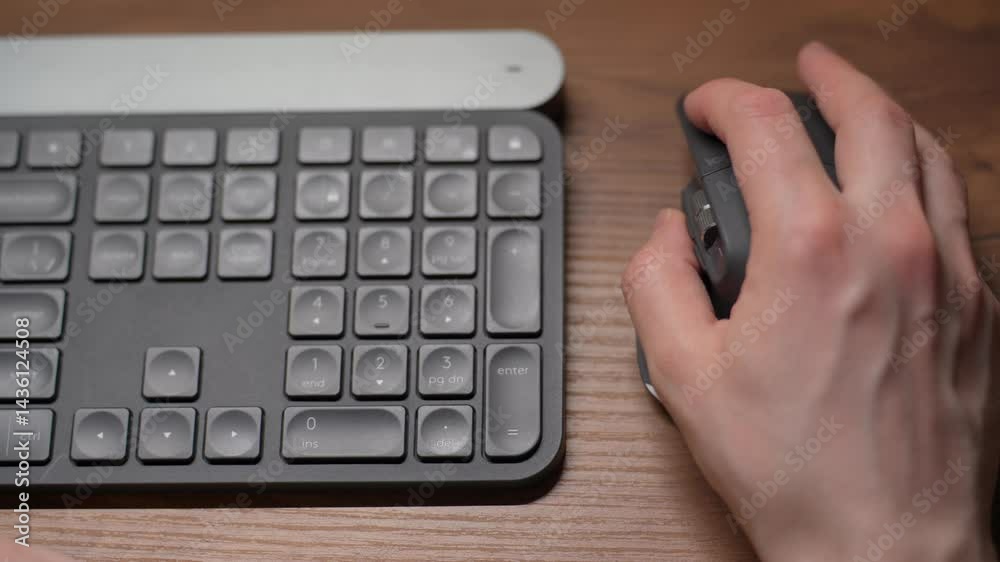 Close-up view of fingers on a keyboard from above. A person typing on the keyboard. Close-up view of fingers on a keyboard from above. A person typing on the keyboard.