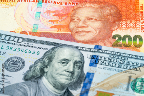 200 South Africa rand and 100 USD dollar banknotes. International trade concept