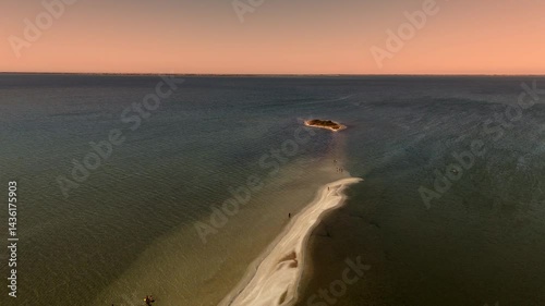 Drone view of a serene lake with an island, revealing its stunning 
