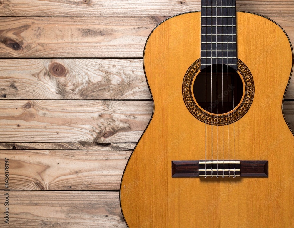 Obraz premium 木目の背景とアコースティックギターとコピースペース