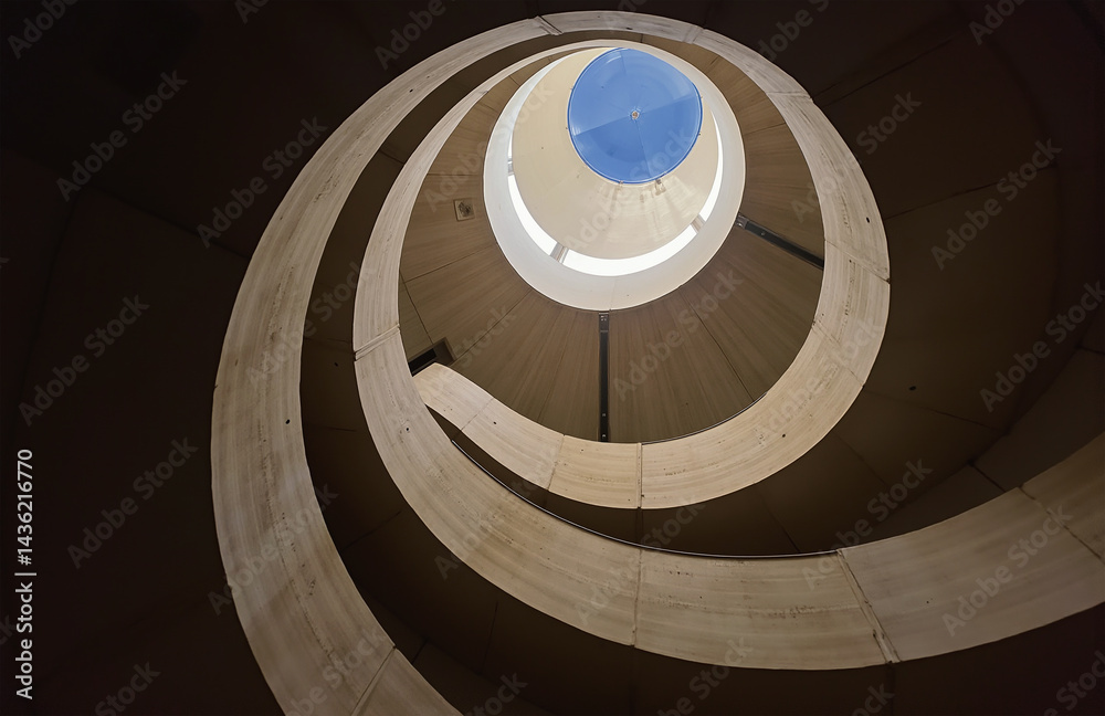 Fototapeta premium Spiral staircase, concrete, natural light, minimalist design, dramatic shadows.