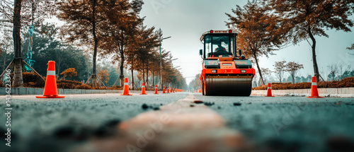 Road roller orange cones roadwork construction asphalt street trees