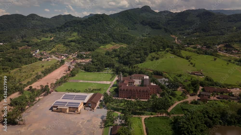 Drone captures a historic church and convent nestled amidst lush tropical mountains. Drone captures a historic church and convent nestled amidst lush tropical mountains.