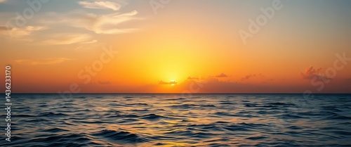 Golden hues paint the sky as the sun rises majestically over calm ocean waves, picture, scenic