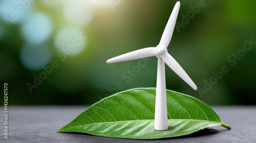 Obraz na płótnie A windmill placed on a green leaf, symbolizing eco-friendly energy. The trend of using renewable and clean energy. Renewable energy support. w salonie
