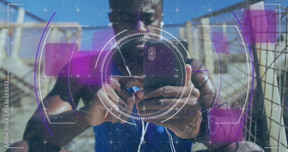 Fototapeta premium Image of scope scanning over african american man using smartphone outdoors