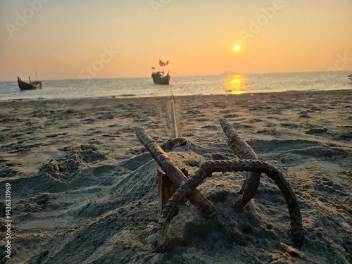 Sunset on the beach, Sunset over the beach with boats and an anchor