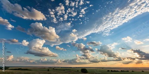 expansive sky filled with fluffy clouds at sunrise