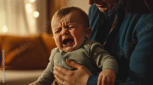 Crying Baby in Mother’s Arms in Cozy Indoor Setting