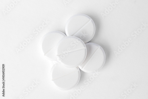 Stack of white paracetamol tablets on clean background, Close-up of several white paracetamol tablets stacked together, isolated on a plain white background, representing healthcare and medicine.