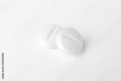 Stack of white paracetamol tablets on clean background, Close-up of several white paracetamol tablets stacked together, isolated on a plain white background, representing healthcare and medicine.