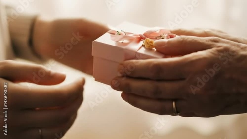 Giving present hands pink gift box ribbon roses love celebration surprise birthday holiday event. Mother's Day is every day.