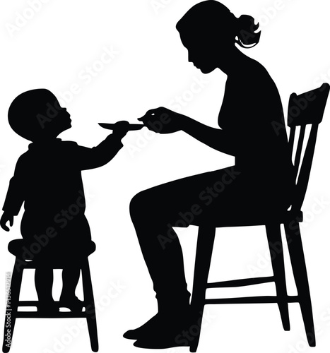 mom feeding toddler in high chair silhouette