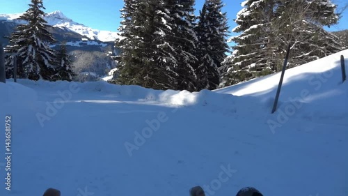 4k UHD POV view video, very fast, breathtaking in its speed, tobogganing on the highway in Bussalp, Grindelwald Switzerland.