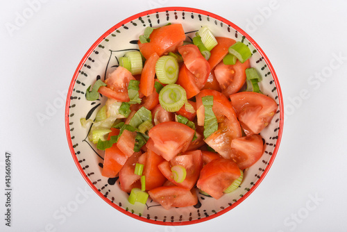 Obraz na płótnie A top-down shot shows a colorful bowl filled with a fresh tomato salad mixed with green onions and basil w salonie