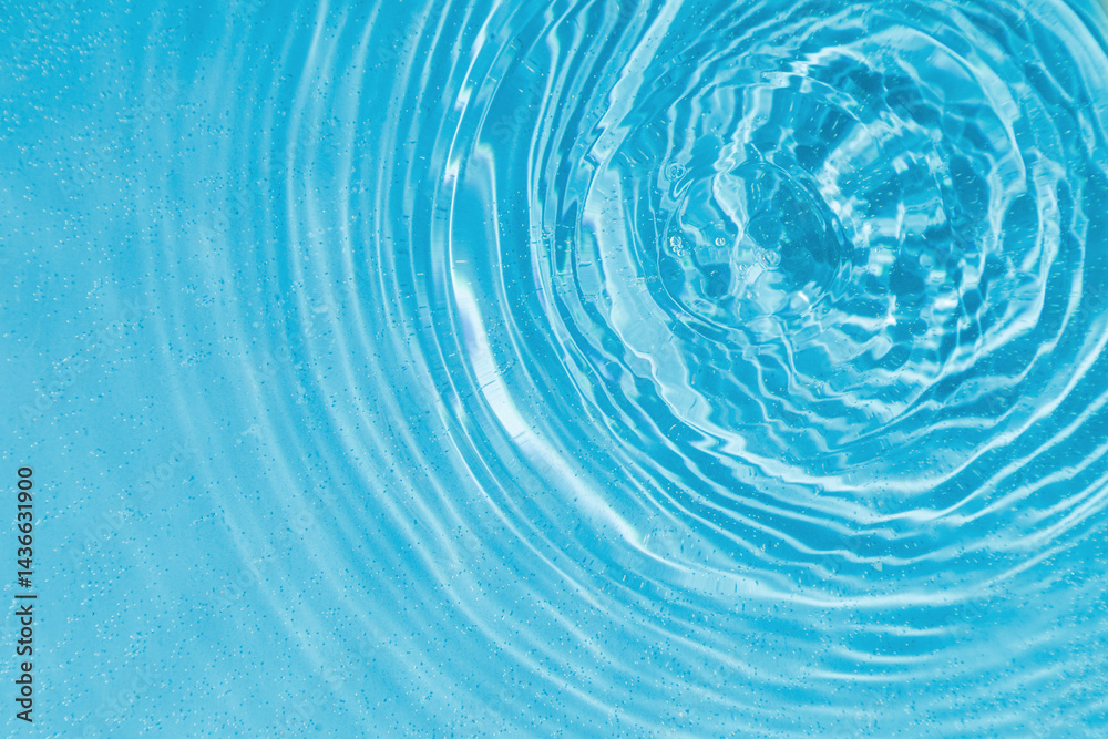 drops on water with circles on a blue background