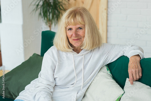 Senior woman enjoying a peaceful moment at home. Comfort, relaxation, wisdom, resilience, mindfulness and serene lifestyle
