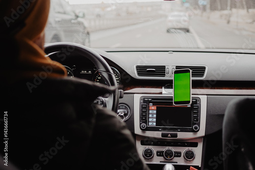 Man drive the car and using mobile app , green screen