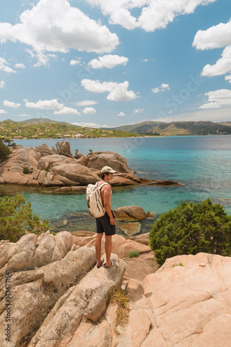 Tourist admiring the sardinian coast on summer holidays