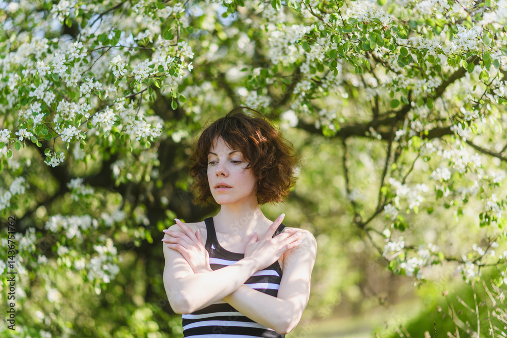 Tender young woman under blooming spring branches. Tender young woman under blooming spring branches.