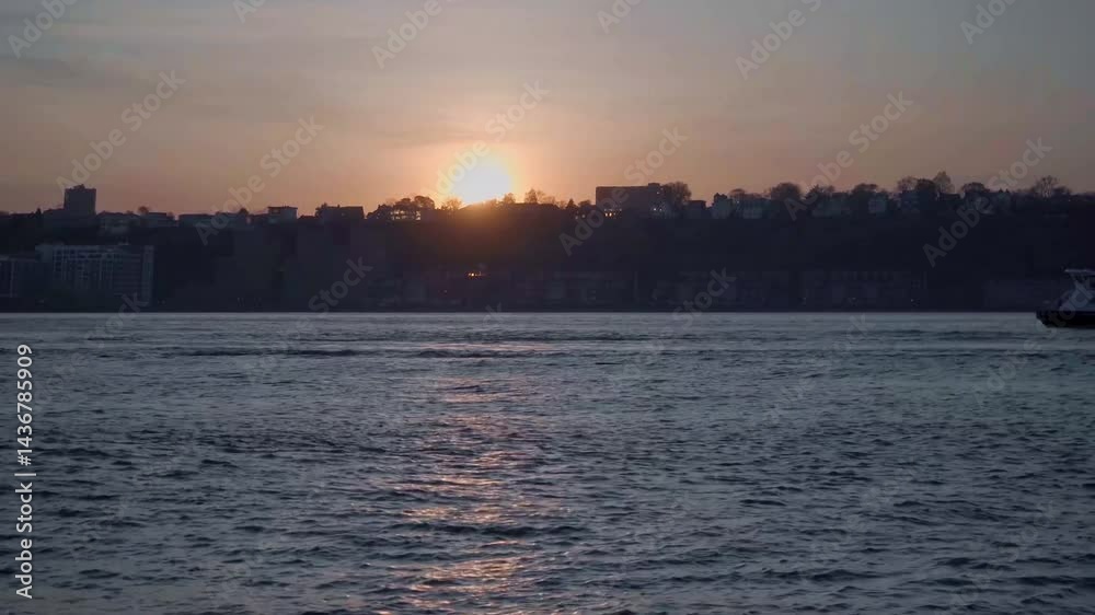 A breathtaking sunset view of a city skyline silhouetted against a vibrant sky, with warm hues of orange and pink blending into cool blue over a calm body of water, creating a serene urban landscape. A breathtaking sunset view of a city skyline silhouetted against a vibrant sky, with warm hues of orange and pink blending into cool blue over a calm body of water, creating a serene urban landscape.