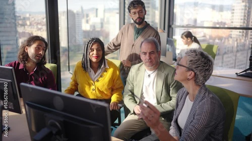 Diverse professional team analyzing complex business data while collaborating near computer, city skyline visible through expansive office window during strategic meeting
