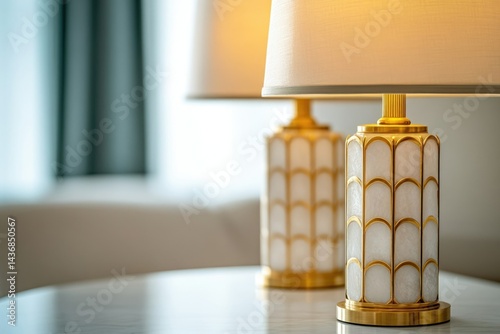 Elegant gold and white table lamps with art deco design illuminate a modern interior.