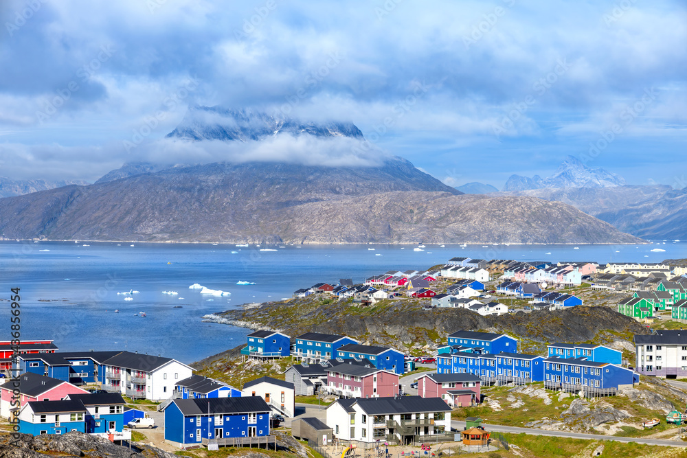Panoramic view of Greenland capital Nuuk with colored houses located near fjords and icebergs.