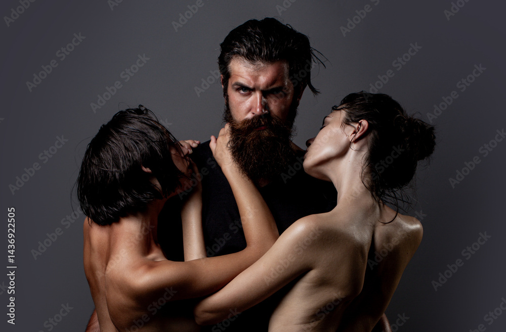 Passionately hugging threesome. A group of sexy models. Threesome concept. Three sexy models together. One man and two sexy women. Polygamy or bigamy. Swinger or trio. Bisexual lady. Prostitution or Passionately hugging threesome. A group of sexy models. Threesome concept. Three sexy models together. One man and two sexy women. Polygamy or bigamy. Swinger or trio. Bisexual lady. Prostitution or