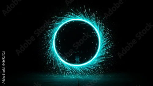 Sparkling teal light circle against a dark background  