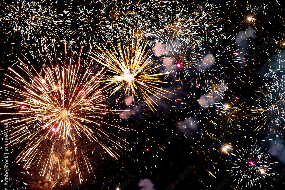 Spectacular fireworks filling the night sky with golden sparks and dazzling light effects