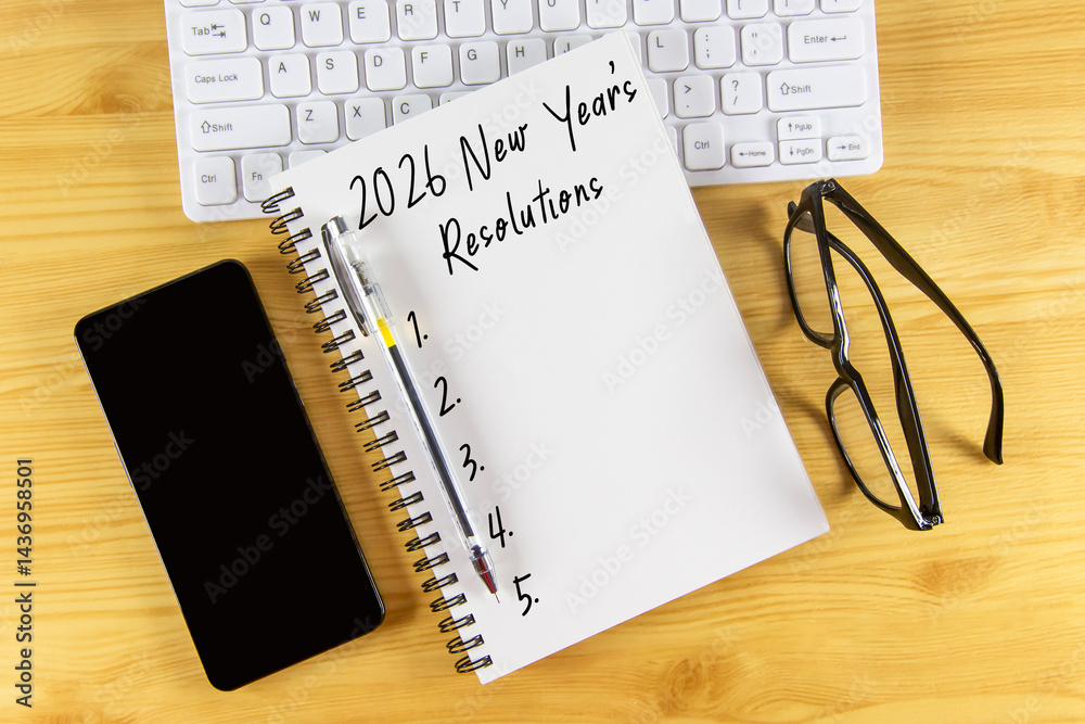 New Year's Resolutions 2026 text on note pad stock photo flat lay