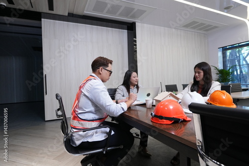 Obraz na płótnie Construction team, engineers and sales marketing team hold a meeting on the progress of the project's construction in the conference room. w salonie