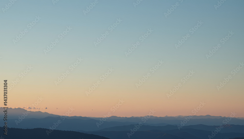 Obraz premium Tranquil landscape reveals distant mountains under soft pastel sky, evoking sense of peace and serenity. gentle gradient of colors enhances beauty of nature canvas